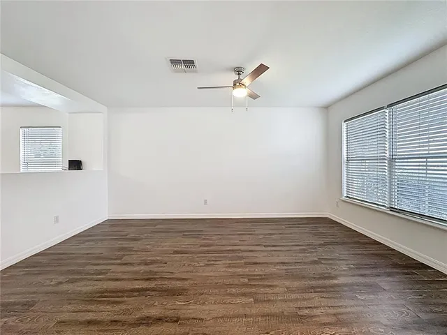 wooden floor in an empty room with a window
