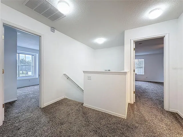 an entryway in a hall with a window