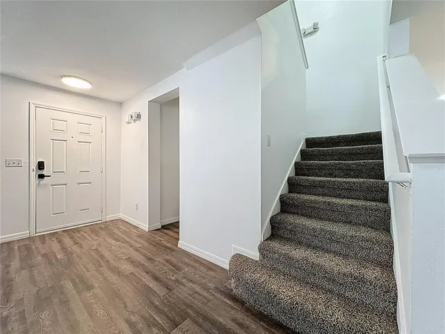 a view of an entryway with wooden floor