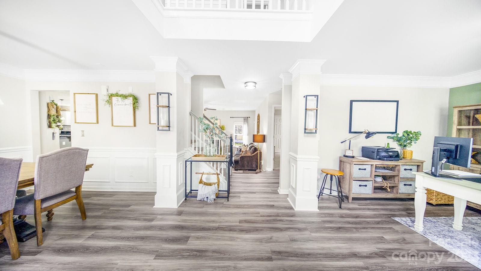 5207 Sunriver Road Gastonia, NC 28054 - Photo 17 of 46 a living room with furniture and a dining table with wooden floor