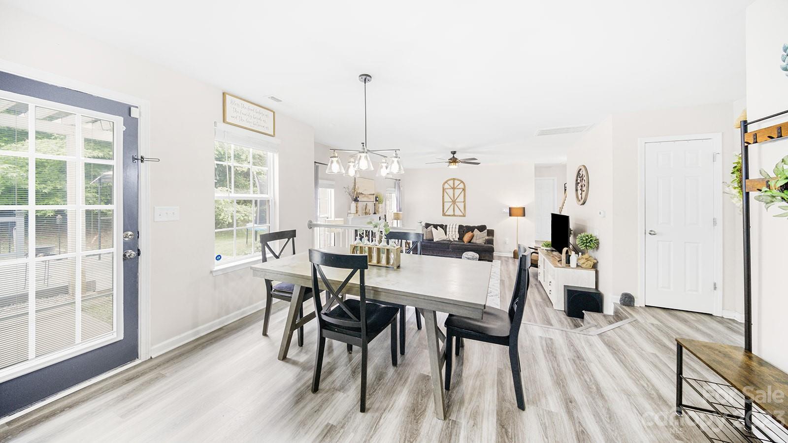 5207 Sunriver Road Gastonia, NC 28054 - Photo 19 of 46 a view of a dining room with furniture window and wooden floor