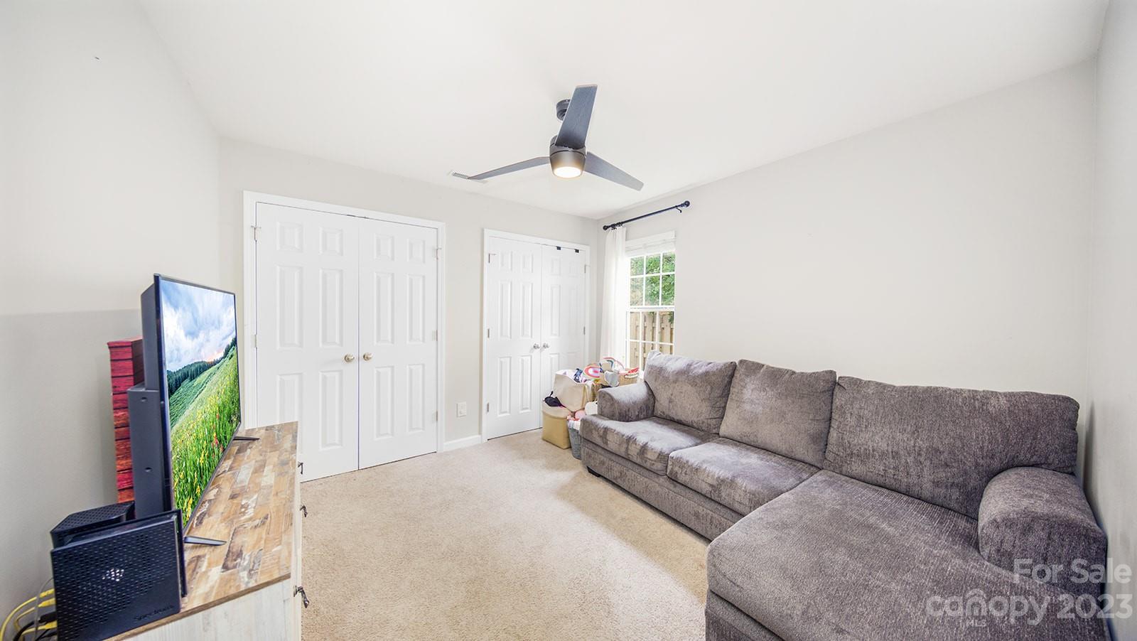 5207 Sunriver Road Gastonia, NC 28054 - Photo 28 of 46 a living room with furniture and a flat screen tv