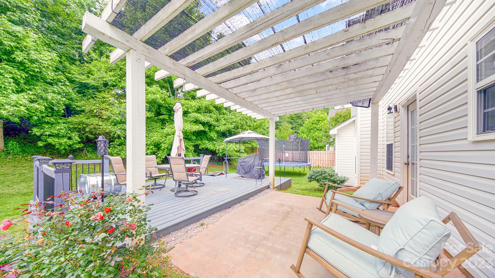 5207 Sunriver Road Gastonia, NC 28054 - Photo 43 of 46 a view of a patio with table and chairs and potted plants