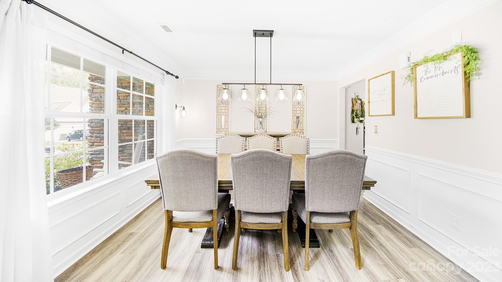 5207 Sunriver Road Gastonia, NC 28054 - Photo 6 of 46 a view of a dining room with furniture window and wooden floor