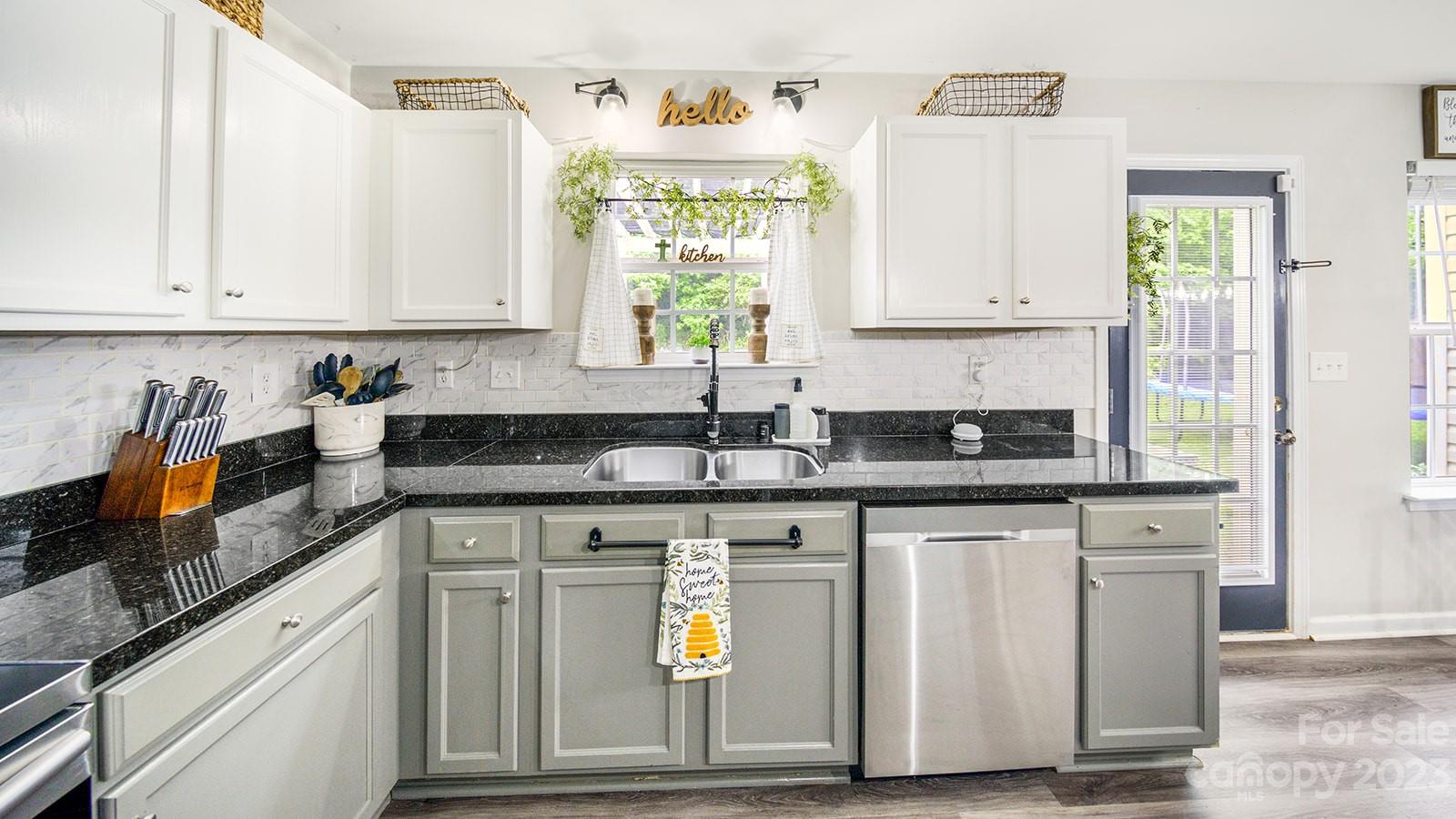 5207 Sunriver Road Gastonia, NC 28054 - Photo 9 of 46 a kitchen with stainless steel appliances granite countertop a stove a sink and a white cabinets
