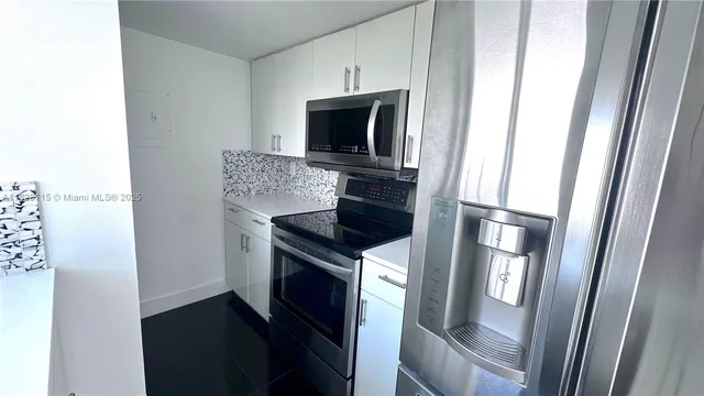 a kitchen with a stove and a refrigerator
