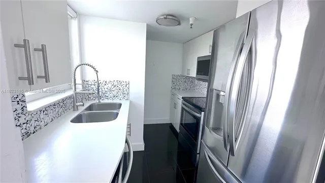 a kitchen with a sink a refrigerator and a sink