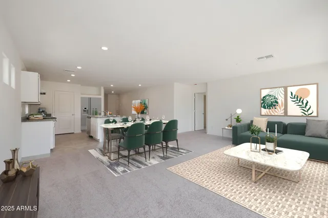 a living room with furniture a dining table and kitchen view