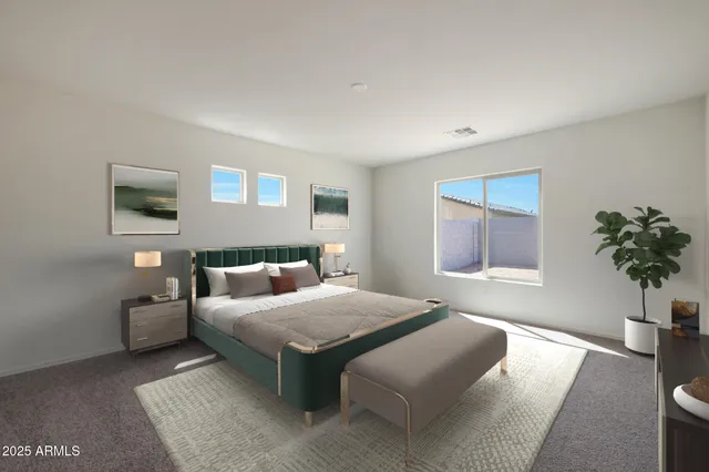 a bedroom with a bed and a potted plant