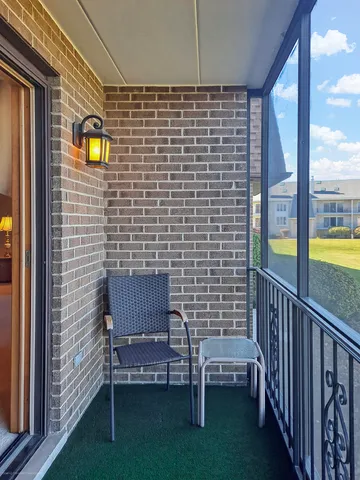 a brick building with a bench and a grill