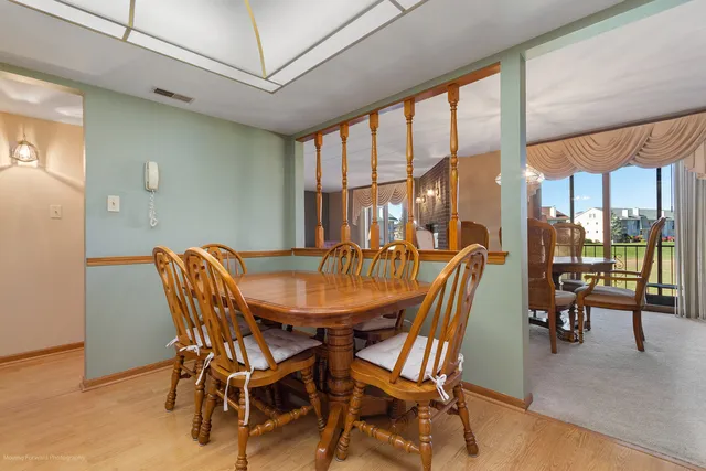 a dining room with furniture and window
