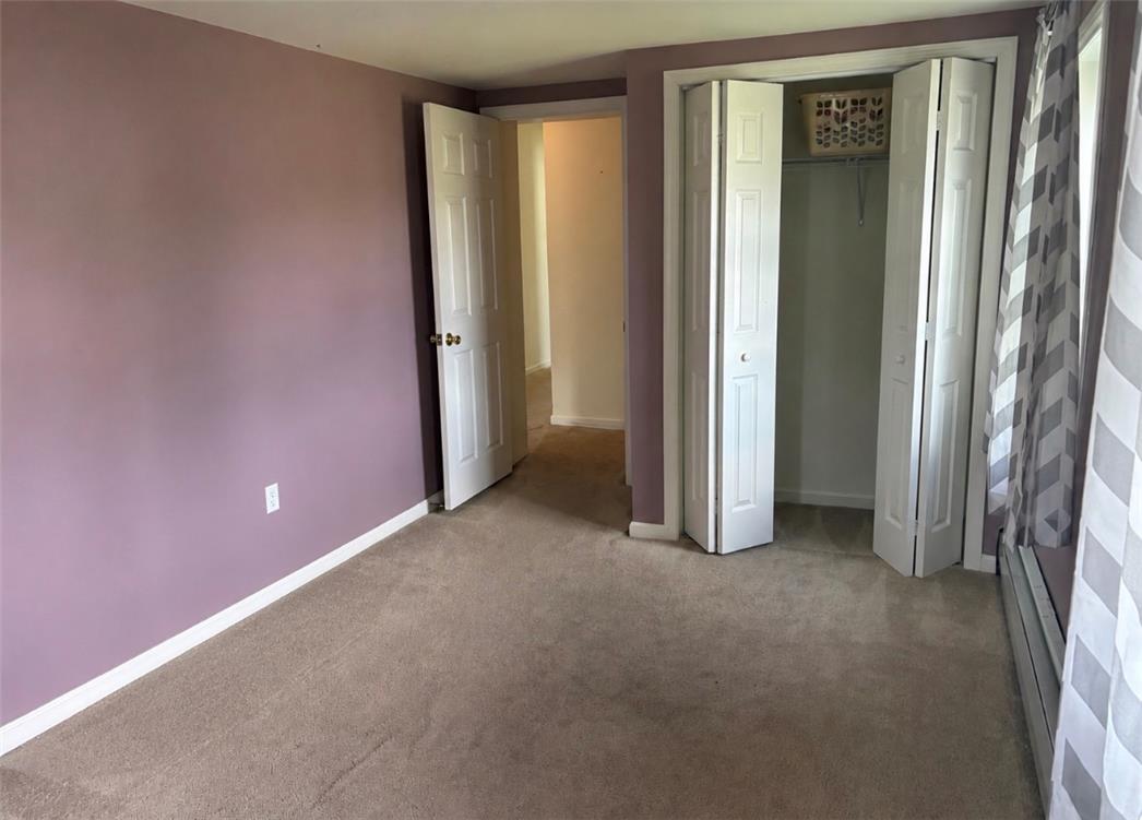 7281 Decatur Street New Tripoli, PA 18066 - Photo 18 of 27 Carpeted bedroom with bifold closet doors and an inviting purple wall.
