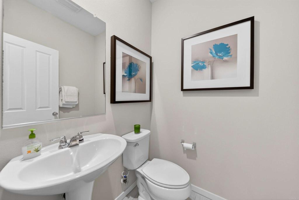 387 Mission Villas Road San Marcos, CA 92069 - Photo 20 of 45 a bathroom with a toilet a sink and mirror