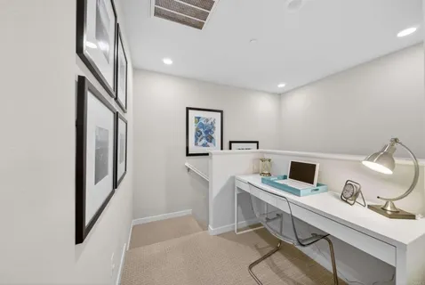 a view of a workspace with furniture and staircase