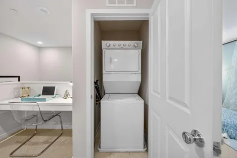 a hallway with a washer and dryer