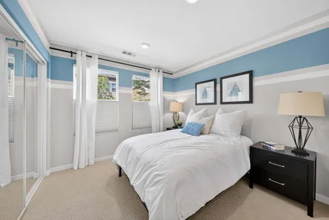 a bedroom with a bed and a night stand