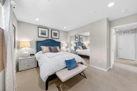 a bedroom with a bed and a night stand