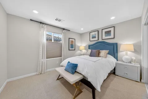 a bedroom with a large bed and a window