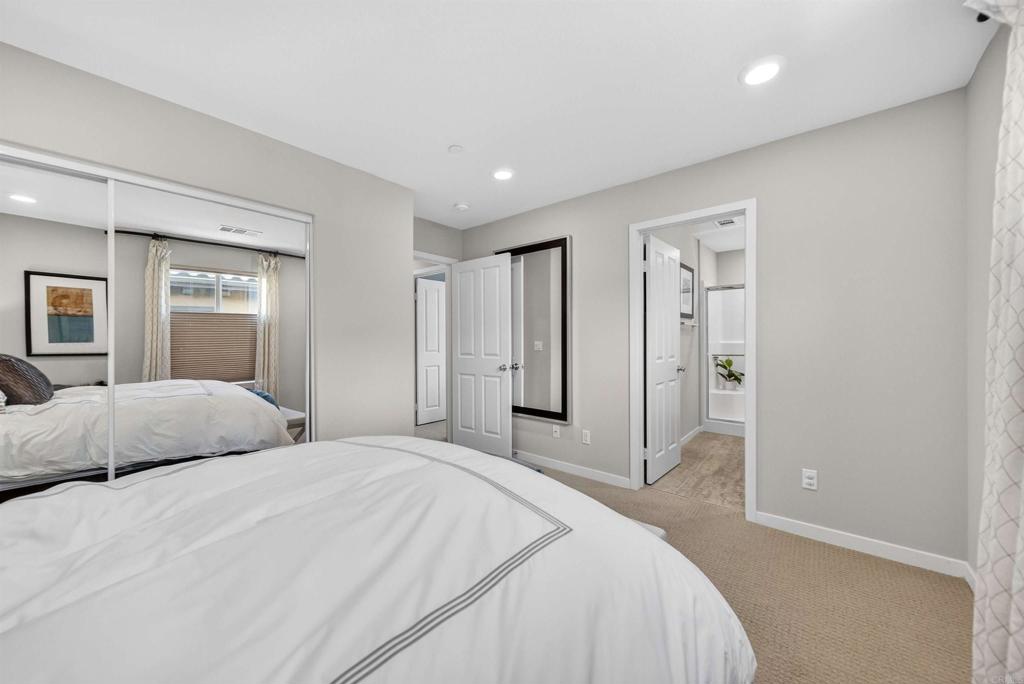 387 Mission Villas Road San Marcos, CA 92069 - Photo 34 of 45 a bedroom with a large bed and a chandelier