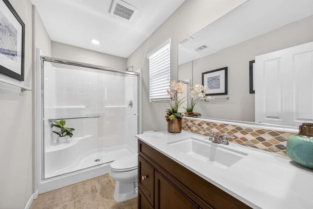 387 Mission Villas Road San Marcos, CA 92069 - Photo 35 of 45 a bathroom with a sink toilet double vanity and shower