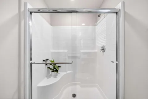 a bathroom with a bathtub and a shower