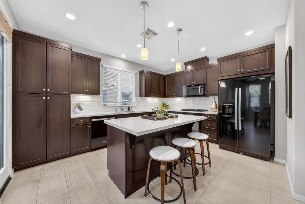 387 Mission Villas Road San Marcos, CA 92069 - Photo 8 of 45 a kitchen with kitchen island a sink stove and refrigerator
