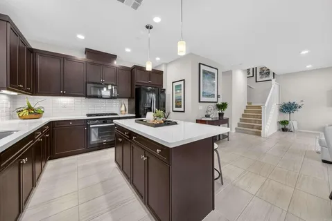 a kitchen with a sink a stove oven and cabinets