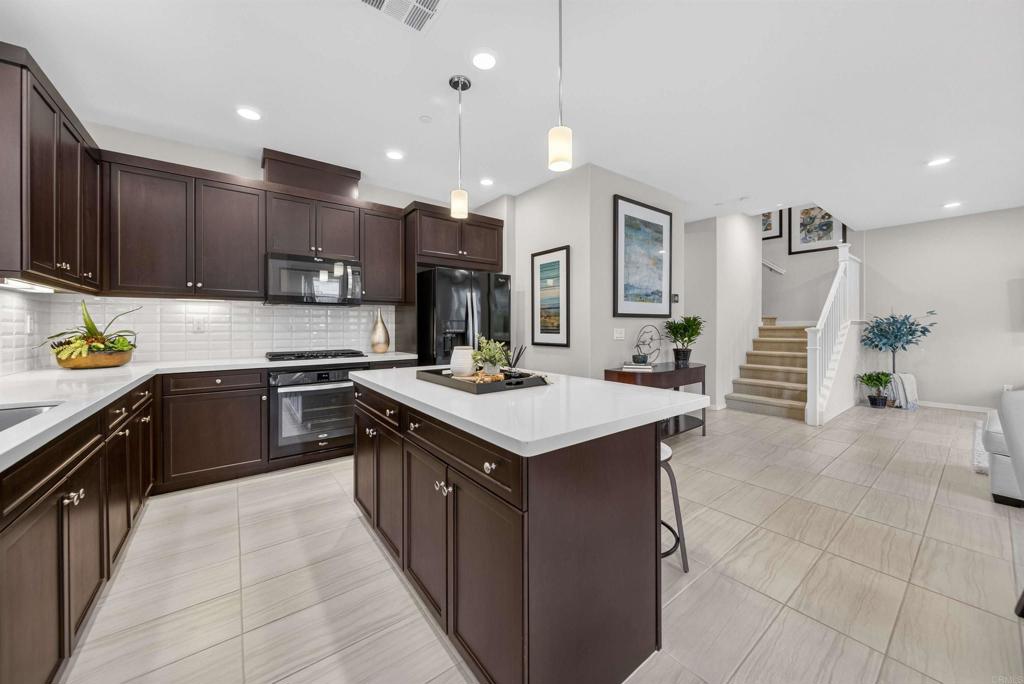 387 Mission Villas Road San Marcos, CA 92069 - Photo 9 of 45 a kitchen with a sink a stove oven and cabinets