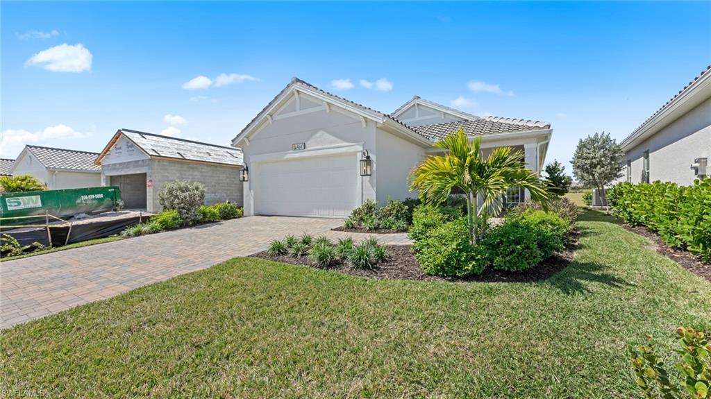 4641 Centaurus Circle Naples, FL 34120 - Photo 2 of 31 a front view of a house with a garden