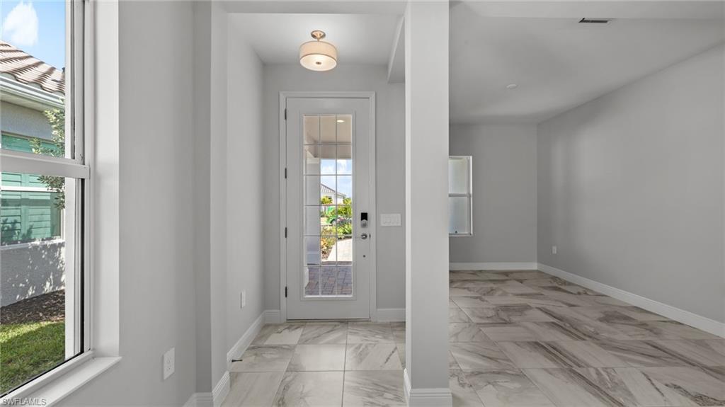 4641 Centaurus Circle Naples, FL 34120 - Photo 4 of 31 an empty room that has a mirror