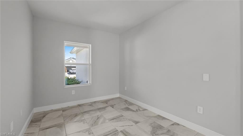 4641 Centaurus Circle Naples, FL 34120 - Photo 9 of 31 an empty room with windows