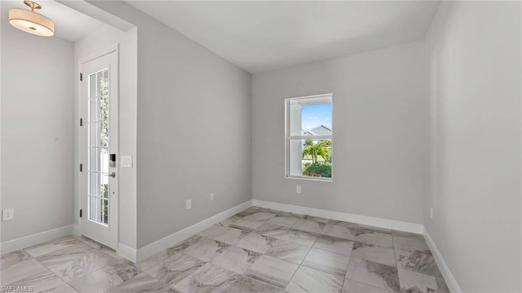 4641 Centaurus Circle Naples, FL 34120 - Photo 10 of 31 an empty room with window and mirror