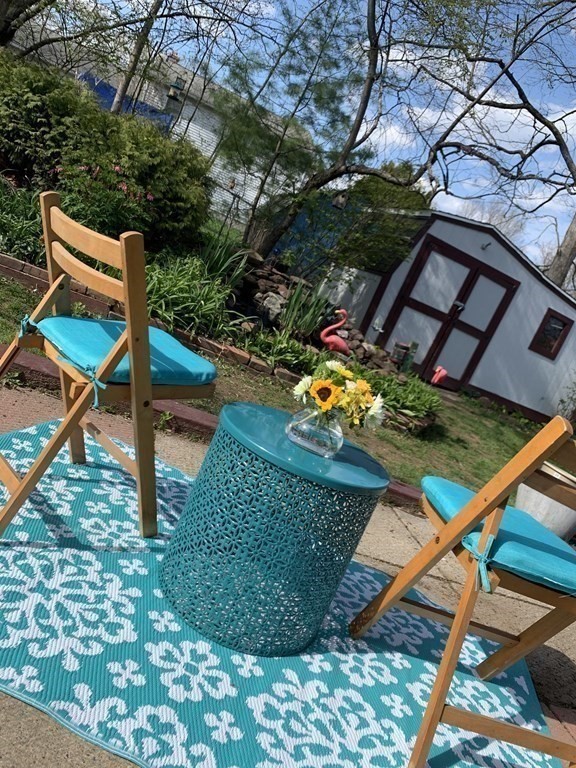 70 Driftwood Road Springfield, MA 01128 - Photo 23 of 25 a backyard of a house with table and chairs