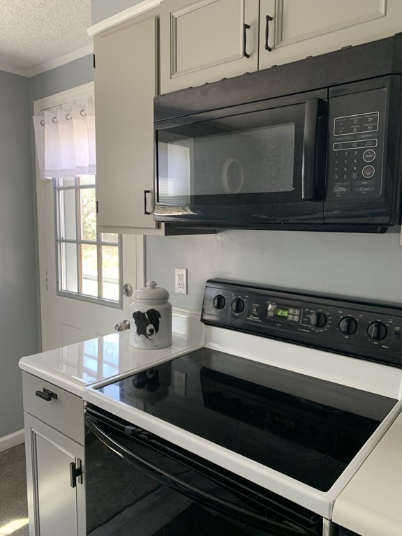 70 Driftwood Road Springfield, MA 01128 - Photo 5 of 25 a kitchen with a stove and a microwave
