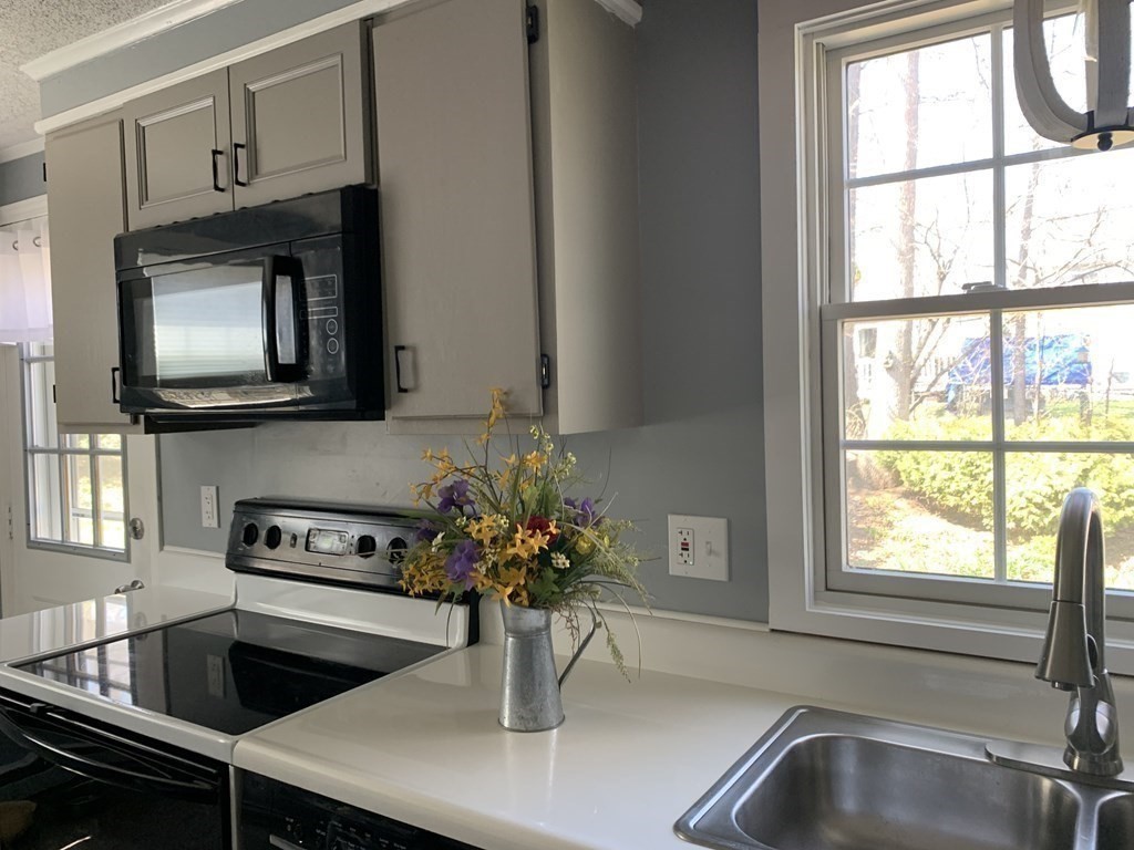 70 Driftwood Road Springfield, MA 01128 - Photo 6 of 25 a kitchen with a sink and a microwave