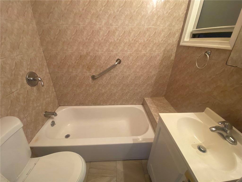 630 53rd Street Brooklyn, NY 11220 - Photo 12 of 14 a bathroom with a sink a toilet and bathtub