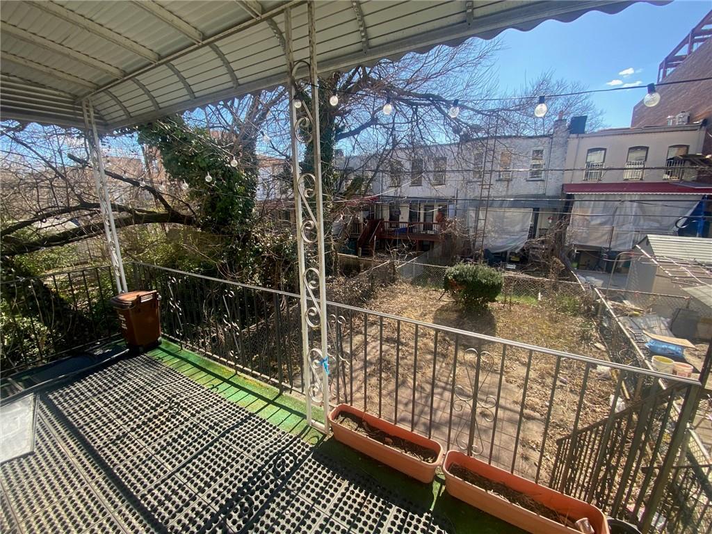630 53rd Street Brooklyn, NY 11220 - Photo 13 of 14 a balcony with lots of wooden furniture