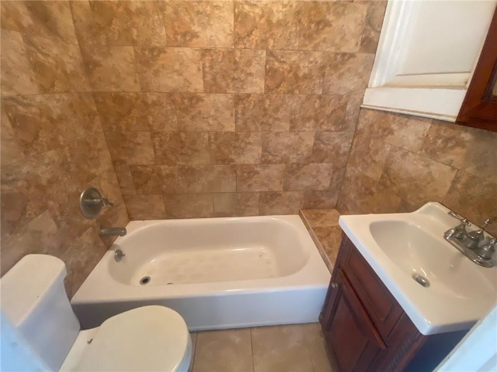630 53rd Street Brooklyn, NY 11220 - Photo 8 of 14 a bathroom with a sink and a bathtub
