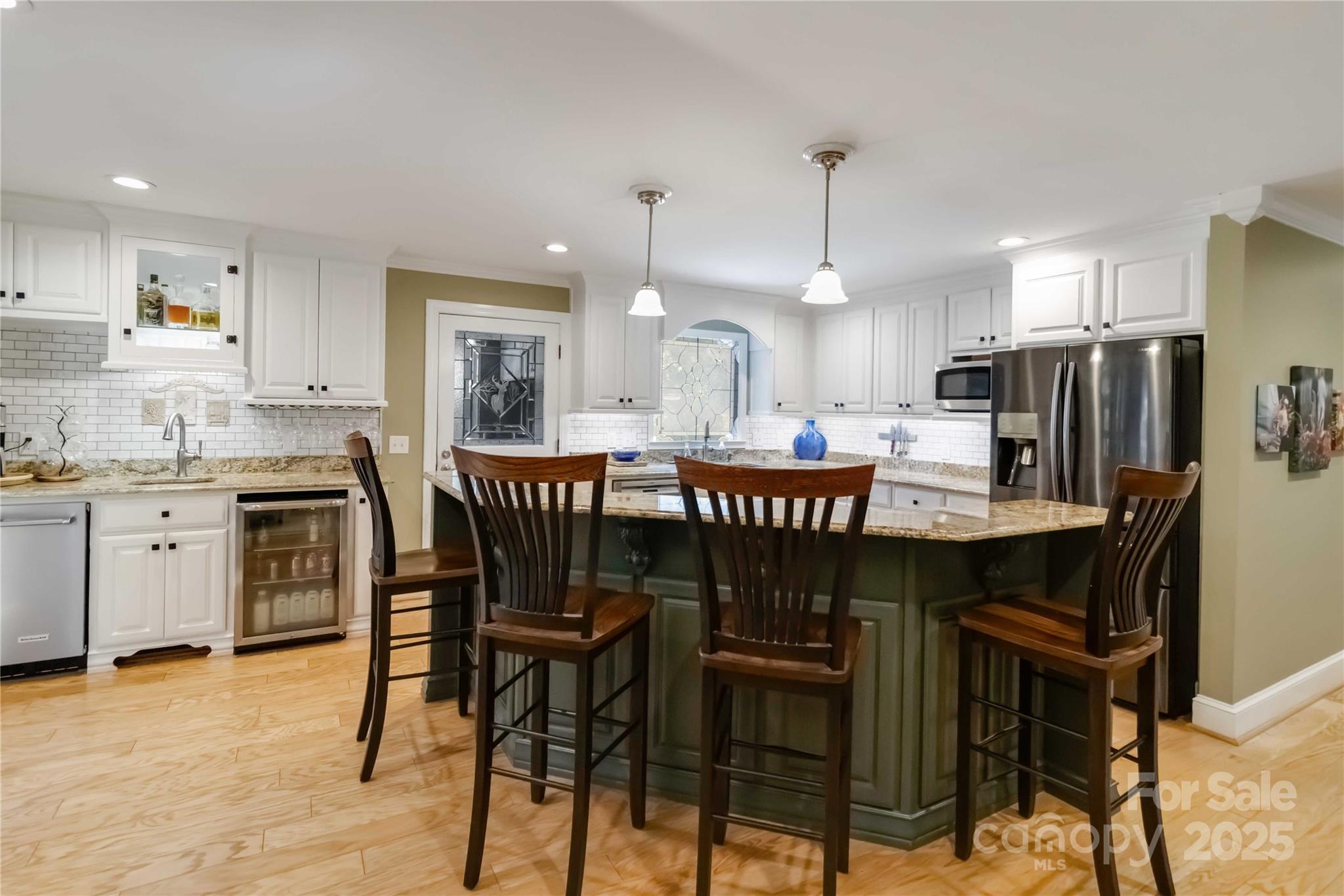2880 Legion Road Smyrna, SC 29743 - Photo 11 of 48 a kitchen with granite countertop a table chairs stove a sink refrigerator and cabinets