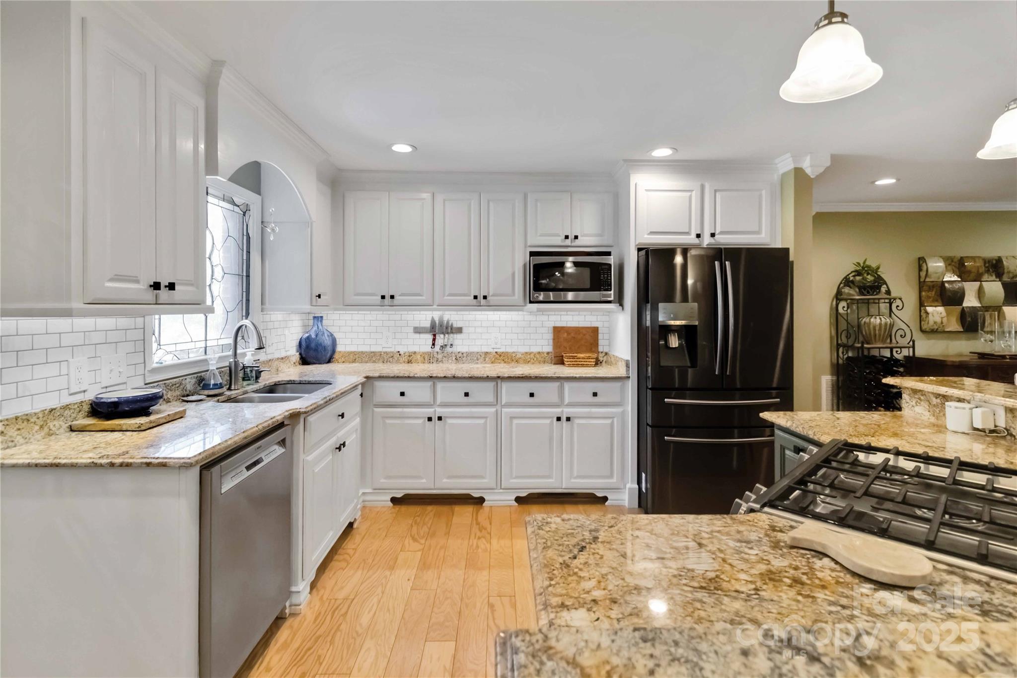 2880 Legion Road Smyrna, SC 29743 - Photo 13 of 48 a kitchen with kitchen island granite countertop a sink stove and refrigerator
