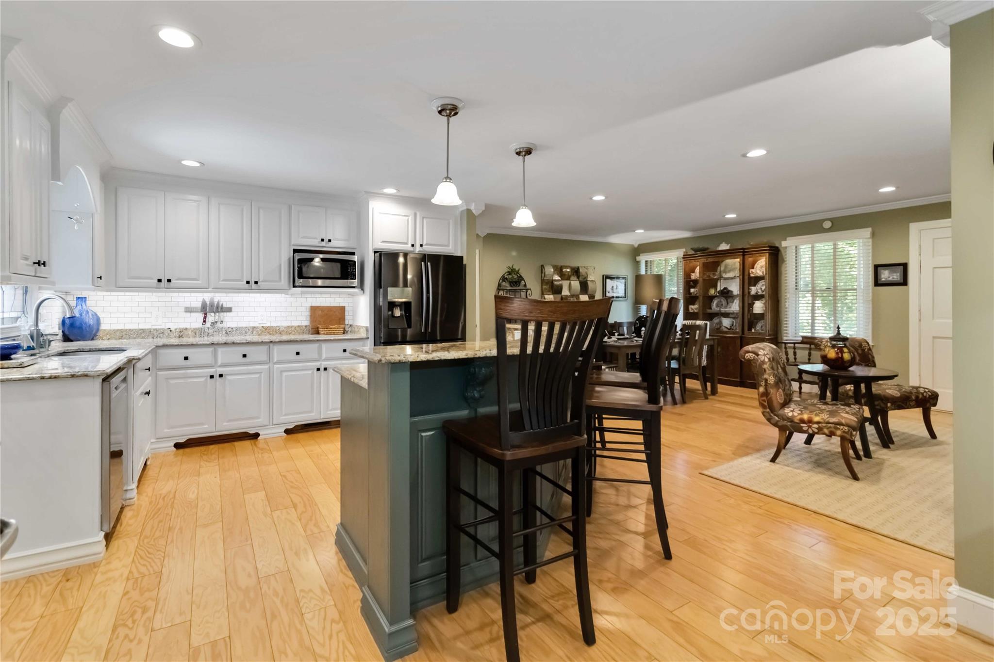 2880 Legion Road Smyrna, SC 29743 - Photo 17 of 48 a kitchen with stainless steel appliances kitchen island granite countertop dining room cabinets and wooden floor
