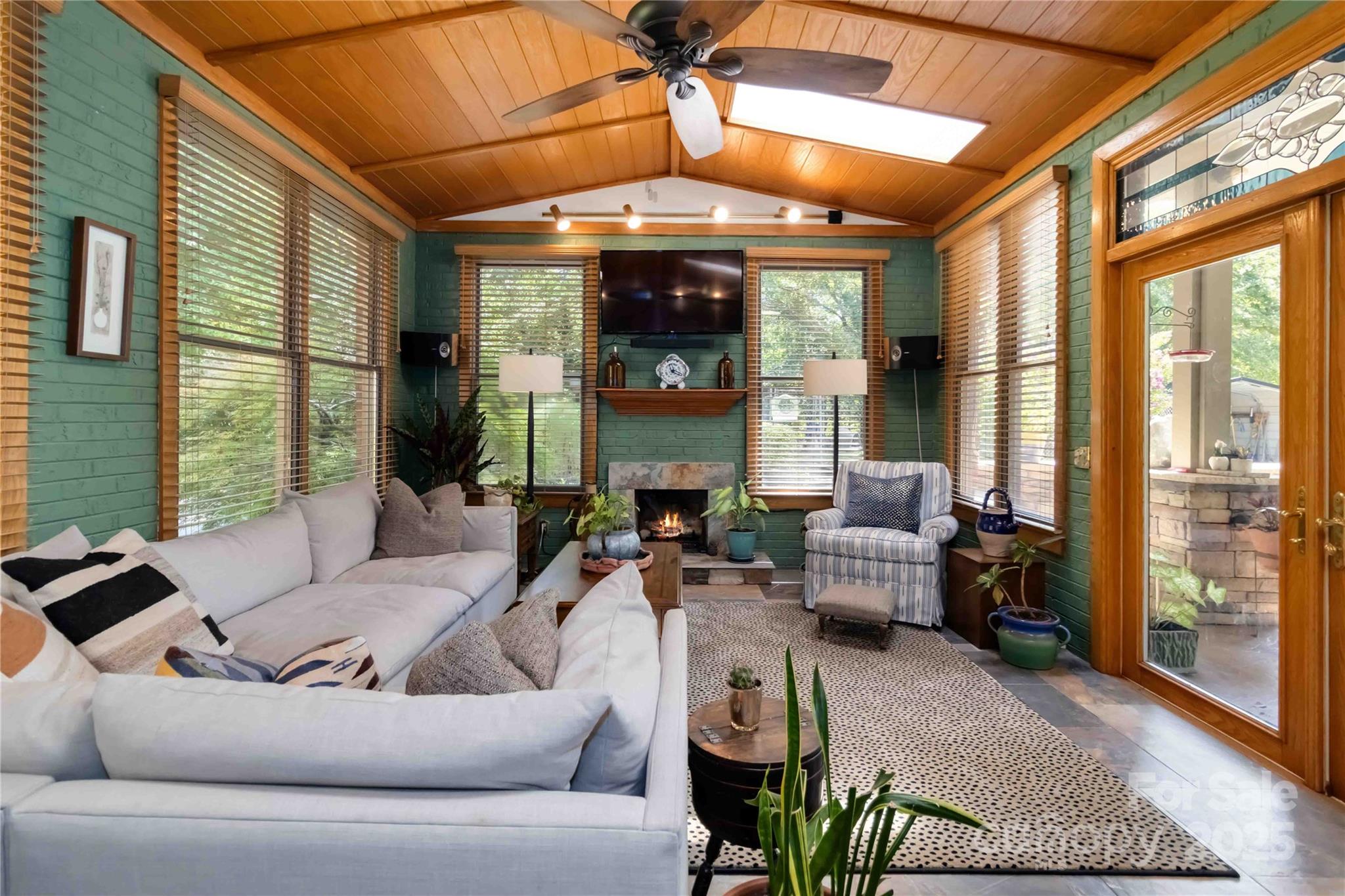 2880 Legion Road Smyrna, SC 29743 - Photo 18 of 48 a living room with furniture fireplace and large windows