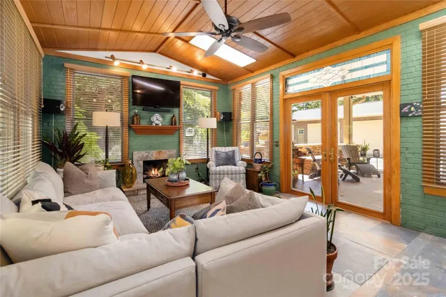a living room with furniture and a floor to ceiling window