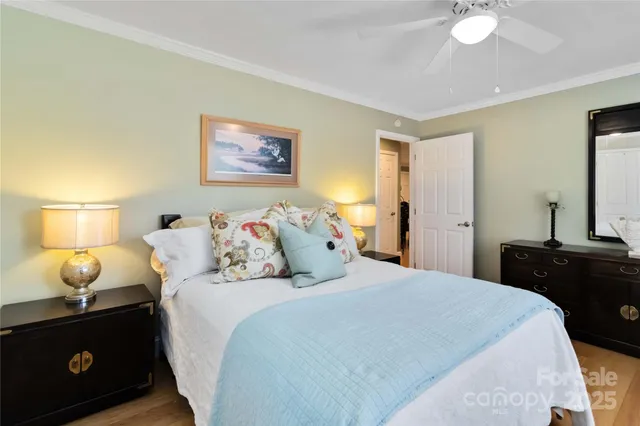 a bedroom with a bed and a lamp on dresser