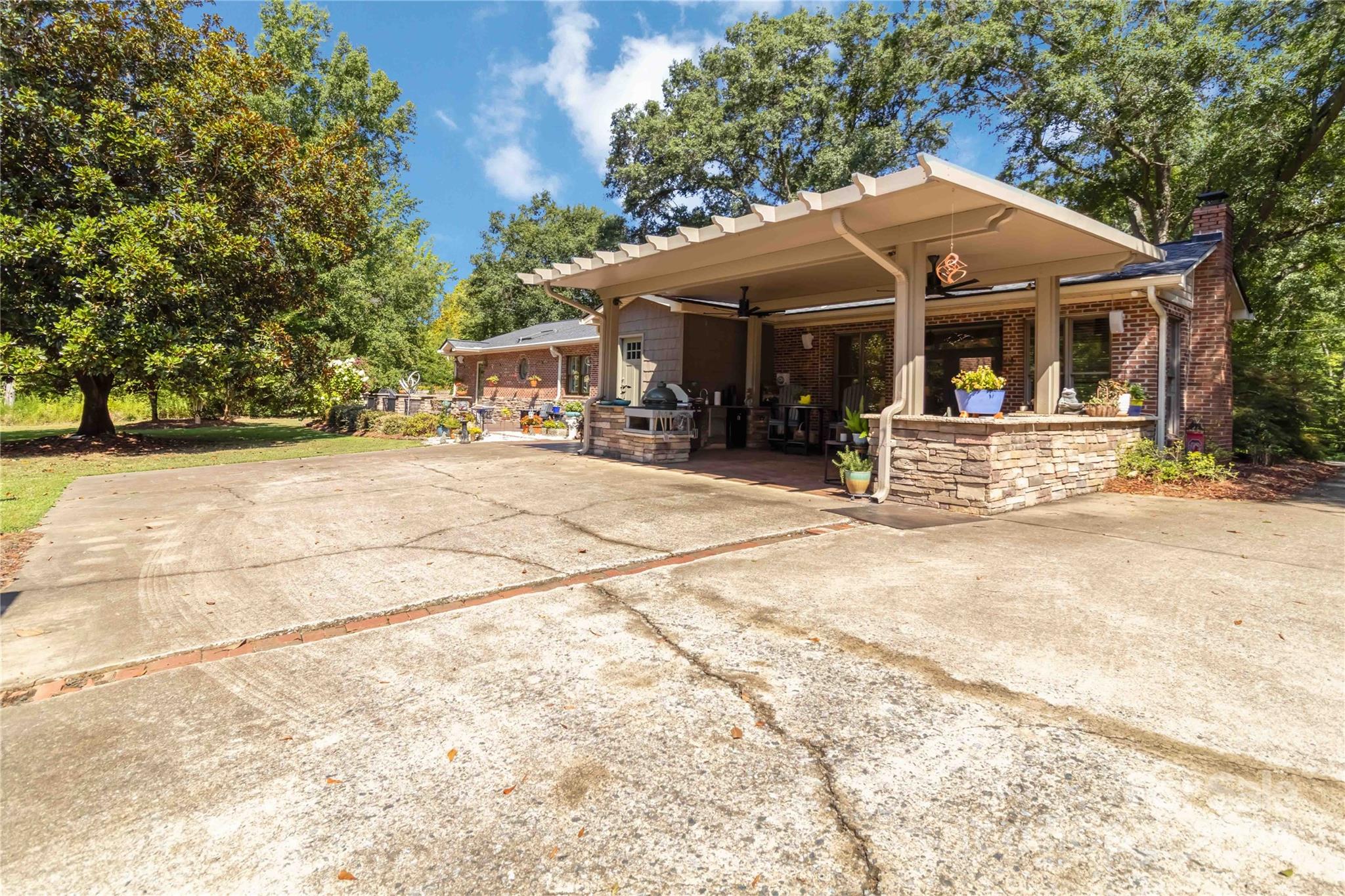 2880 Legion Road Smyrna, SC 29743 - Photo 39 of 48 a patio with a table and chairs under an umbrella