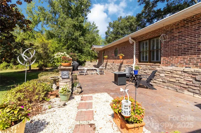 a view of a patio with table and chairs and potted plants