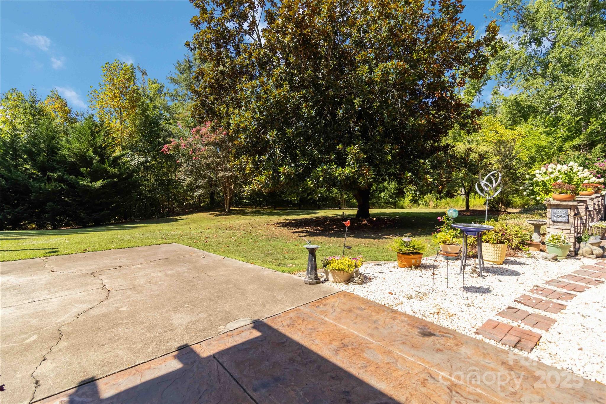 2880 Legion Road Smyrna, SC 29743 - Photo 44 of 48 a view of a swimming pool with a lawn chairs under an umbrella