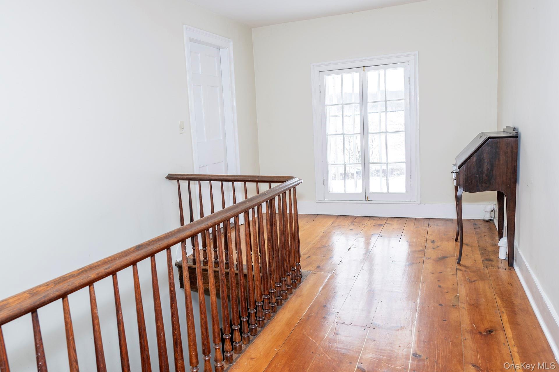 79 Camby Road Millbrook, NY 12545 - Photo 23 of 34 a view of a hallway with wooden floor and staircase