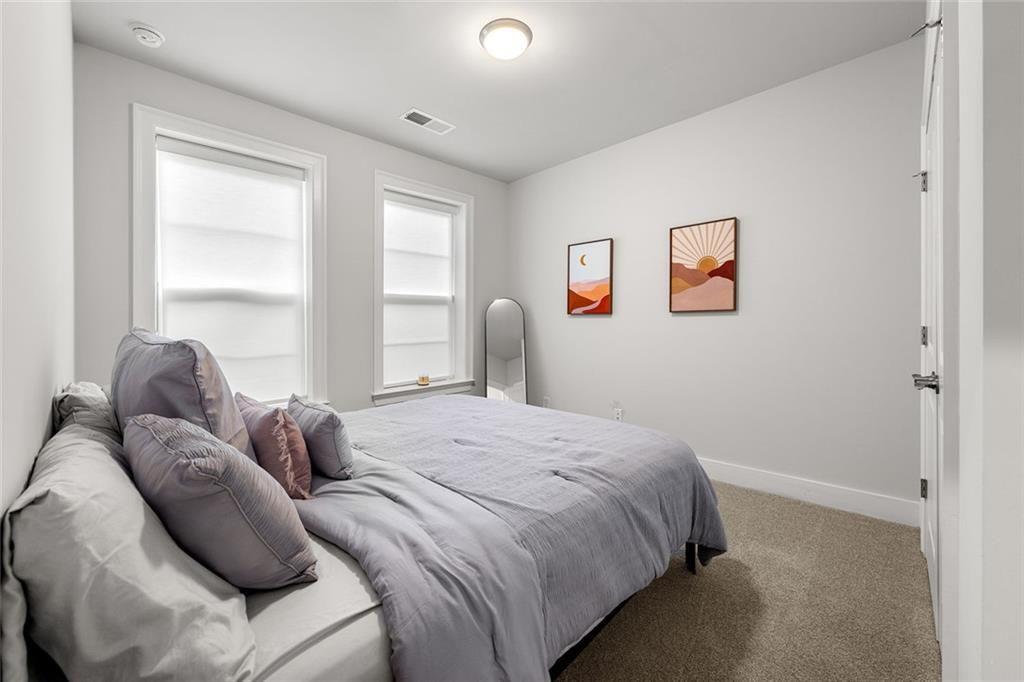 1012 Burnside Ln. Northwest Atlanta, GA 30318 - Photo 19 of 36 a bedroom with a bed and a window