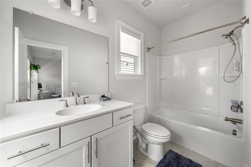 1012 Burnside Ln. Northwest Atlanta, GA 30318 - Photo 26 of 36 a bathroom with a sink a toilet and shower